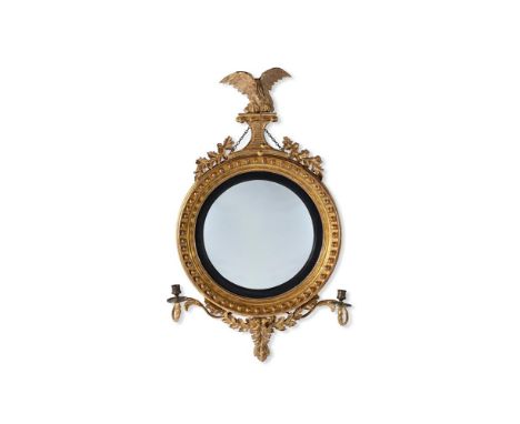 A REGENCY CARVED GILTWOOD CONVEX GIRANDOLE MIRROR  CIRCA 1815 With two candle arms  96cm high, 60cm wide   Condition Report: 