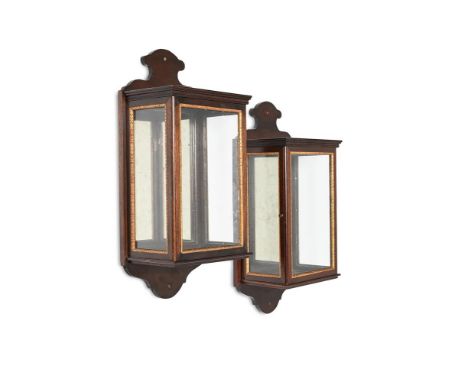 A PAIR OF MAHOGANY AND PARCEL GILT WALL LANTERNS  IN GEORGE III STYLE, PROBABLY BY COLEFAX & FOWLER 58.5cm high, 27cm wide, 1