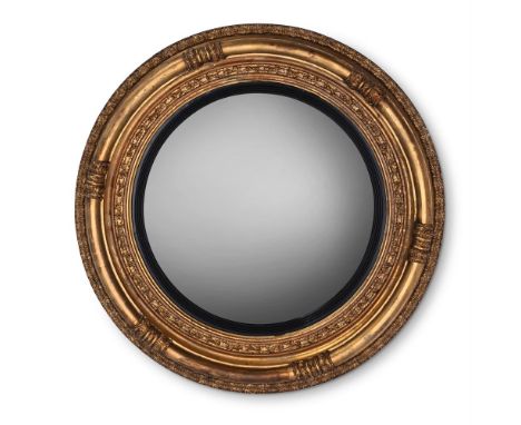 A LARGE REGENCY GILTWOOD CONVEX MIRROR CIRCA 1815 83cm diameter, 11cm deep  Provenance: Private Collection Acquired from Vict