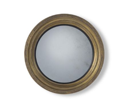 A LARGE REGENCY GILTWOOD CONVEX MIRROR CIRCA 1815 72.5cm diameter, 8cm deep  A closely related mirror sold in these rooms, Fi