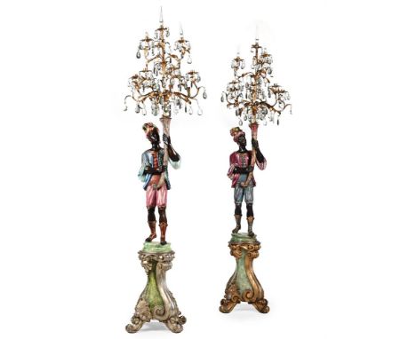 A PAIR OF CARVED AND POLYCHROME DECORATED MORETTO TORCHERES  PROBABLY ITALIAN, EARLY 20TH CENTURY  Each figure supporting 6 l