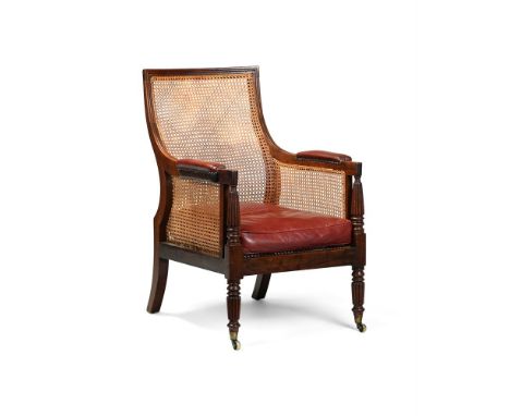 A REGENCY MAHOGANY LIBRARY BERGERE ARMCHAIR ATTRIBUTED TO GILLOWS, CIRCA 1815 103cm high, 69cm wide, 74cm deep  Provenance: T