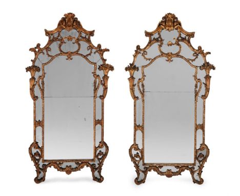 A LARGE PAIR OF EARLY LOUIS XV CARVED GILTWOOD AND GESSO MIRRORS CIRCA 1730 With marginal mirror plates 220cm high, 127cm wid