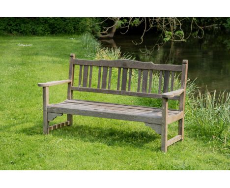 HMS WEYMOUTH, A TEAK GARDEN BENCH  CIRCA 1929  By Hughes Bolckow Blyth, Northumberland, with large flat "drinks" arms, metal 