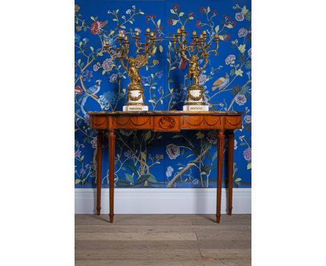 Y  A GEORGE III SATINWOOD AND MARQUETRY SERPENTINE SIDE OR CONSOLE TABLE IN THE MANNER OF WILLIAM MOORE OF DUBLIN, CIRCA 1775