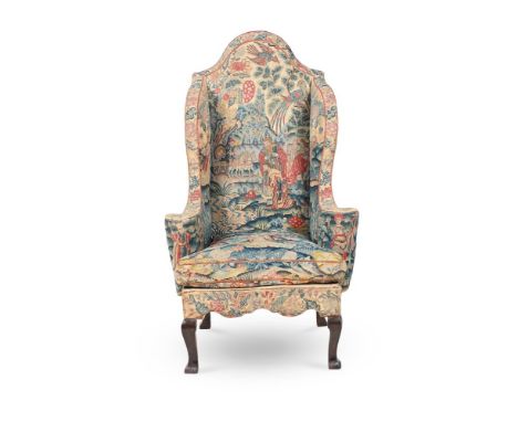 A FINE AND RARE QUEEN ANNE NEEDLEWORK WALNUT AND BEECHWOOD WING ARMCHAIR  CIRCA 1710-1715 The serpentine crest rail flanked b