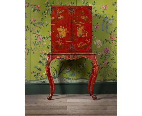 A RED LACQUER AND JAPANNED CABINET ON STAND EARLY 19TH CENTURY Painted with Chinese figures and flowering branches, the doors
