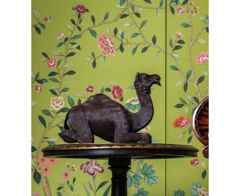 Y  A CARVED EXOTIC HARDWOOD MODEL OF A RECUMBENT CAMEL  LATE 19TH CENTURY  27cm high, 12cm wide, 35cm long   A closely relate