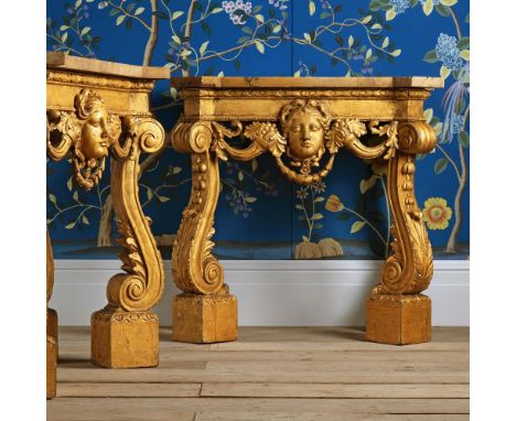 A PAIR OF CARVED GILTWOOD AND MARBLE TOPPED CONSOLE TABLES IN THE MANNER OF DESIGNS BY WILLIAM KENT, 19TH CENTURY 80cm high, 