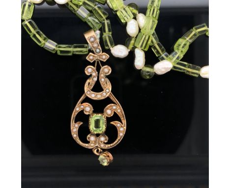 A 9ct YELLOW GOLD PERIDOT AND SEED PEARL ART NOUVEAU PENDANT DATED 1907, BIRMINGHAM, LATER SUSPENDED ON A GREEN BEADED AND BA