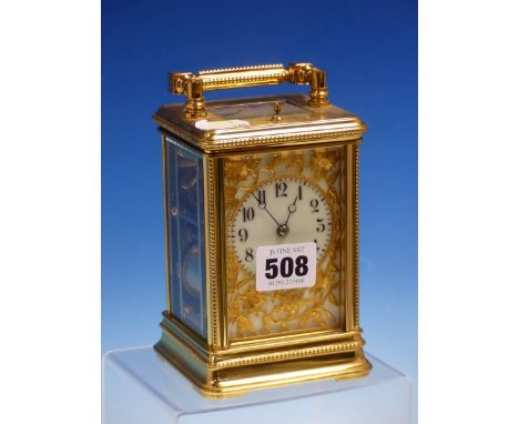 A CARRIAGE CLOCK IN GLAZED BEADED CASE STRIKING AND REPEATING ON A COILED ROD, THE DIAL WITH ARABIC NUMERALS, THE CHAPTER RIN