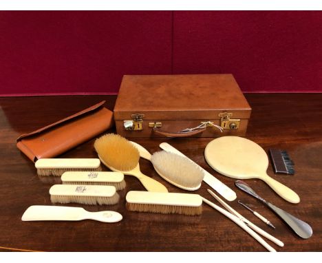 A SWAINE BRIGG LEATHER BRUSH AND COMB FOLDER, TOGETHER WITH PART BRUSH SETS IN IVORY AND IVORINE AND A SMALL LEATHER BRIEF CA