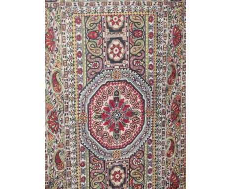 AN INDO-BURMESE SILK PANEL EMBROIDERED CENTRALLY WITH THREE HEXAGONS WITHIN BANDS OF BUDS AND FLOWER HEADS, THE GILT FRAME.  