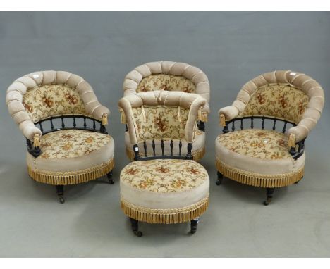 A SET OF THREE EBONISED LATE VICTORIAN SALON ARMCHAIRS UPHOLSTERED IN BEIGE GROUND FLORAL TEXTILE, THE TOP RAILS CORD BOUND A