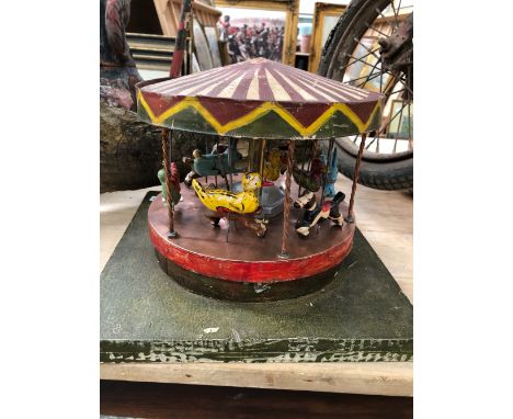 AN APPARENTLY SCRATCH BUILT HAND CRANKED AUTOMATON MERRY-GO-ROUND.&nbsp; Dia. 25cms.