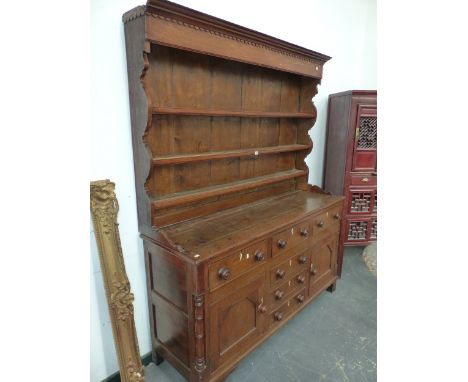 A 19th C. OAK DRESSER, THE ENCLOSED THREE SHELF BACK RECESSED ABOVE THE BASE WITH FOUR DRAWERS CENTRAL TO DRAWERS OVER CUPBOA