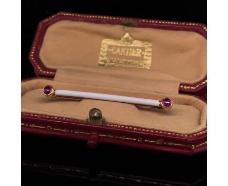 A CARTIER 14ct GOLD WHITE ENAMEL AND CABOCHON RUBY BAR BROOCH IN A CARTIER FITTED CASE. SIGNED CARTIER,PARIS, LONDON, NEW YOR