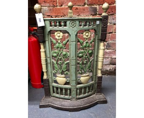 A VICTORIAN AESTHETIC TASTE CAST IRON STICK STAND, THE TRIANGULAR BACK WITH A ROUNDED FRONT PIERCED AND CAST WITH TWO PANELS 