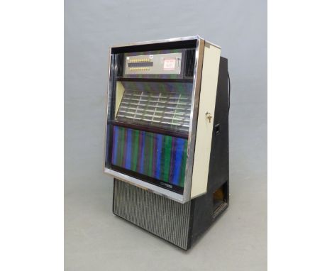 A MODEL ESB100 SEEBURG STENCO PHONOGRAPH JUKE BOX WITH A SELECTOR OF NAMED 45RPM SINGLES AND A BLUE, MAUVE AND GREEN LIGHT DI