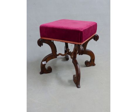 A VICTORIAN ROSEWOOD STOOL UPHOLSTERED IN RED, THE BRACKET SHAPED LEGS JOINED BY SPIRAL TURNED CYLINDRICAL STRETCHERS.   W 43