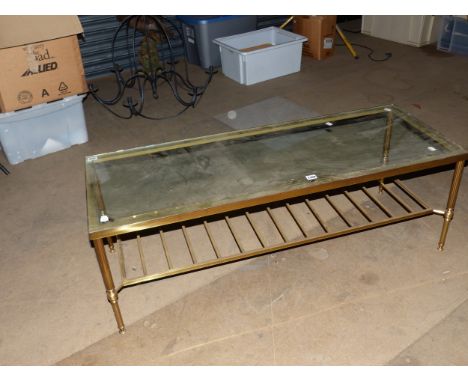 A GLAZED BRASS COFFEE TABLE, THE REEDED TAPERING CYLINDRICAL LEGS JOINED BY A LADDER TIER.   W 121 x D 45.5 x H 42cms.