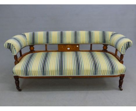 A LATE VICTORIAN ROSEWOOD SETTEE, THE SHOW FRAME BARS TO THE BACK INLAID WITH SWAGS FLANKED BY ROSETTES BELOW THE BACK TOP RA