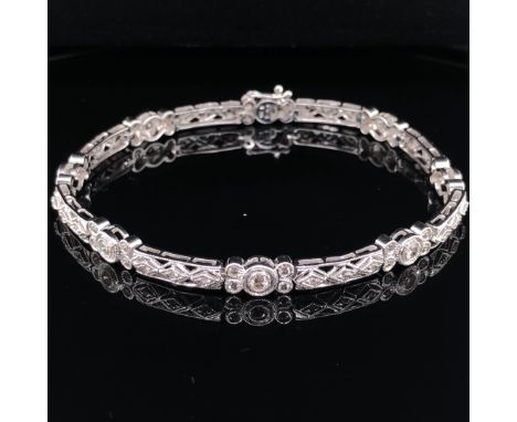 A 9ct WHITE GOLD AND DIAMOND EDWARDIAN STYLE FILIGREE PANEL BRACELET.  ESTIMATED DIAMOND WEIGHT 1.03cts. WEIGHT 8.4grms. LENG