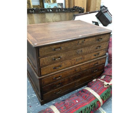 A VINTAGE OAK CHART OR PLAN CHEST OF TWO HALVES EACH WITH THREE LONG DRAWERS, THE BASE HALF WITH PLINTH FOOT.   W 119 x D 84 