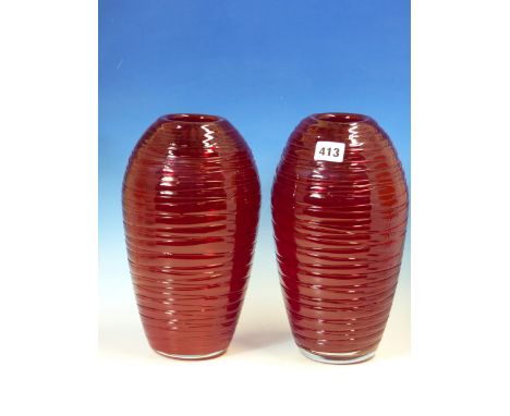 A PAIR OF RUBY GLASS OVOID VASES HORIZONTALLY TRAILED IN POWELL STYLE.   H 28cms.