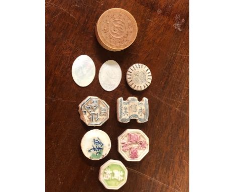 SIX CHINESE CERAMIC GAMES TOKENS TOGETHER WITH A SINGLE MOTHER OF PEARL COUNTER AND MORE IN A DEDICATED CARVED IVORY BOX.   D