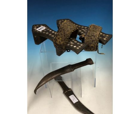 A PAIR OF TURKISH MOTHER OF PEARL INLAID HAMMAM SHOES TOGETHER WITH TWO WHITE METAL KOFTGARI IRON DAGGERS AND SCABBARDS