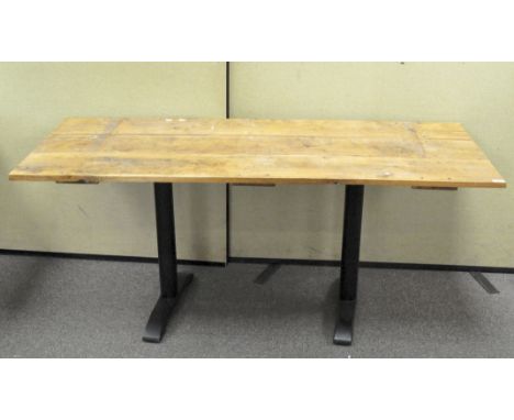 A vintage wooden door adapted into a table top, mounted two metal legs, 73cm x 170cm x 71cm