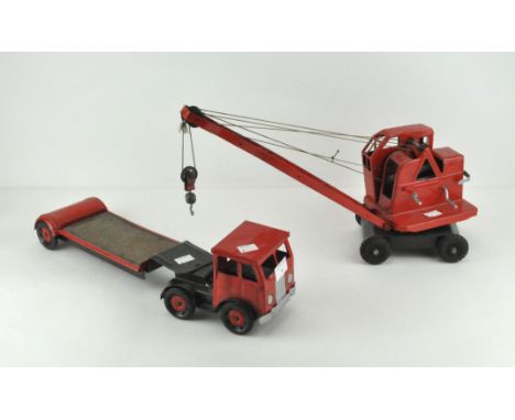 A vintage metal toy crane on matching transport lorry. Lorry length 38cm.