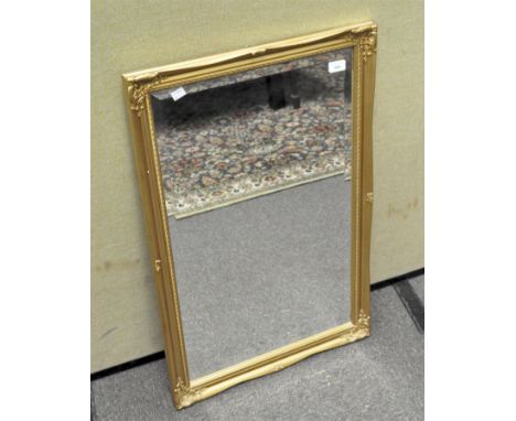 A vintage gilt framed bevelled edged mirror of rectangular form, 86cm x 55cm