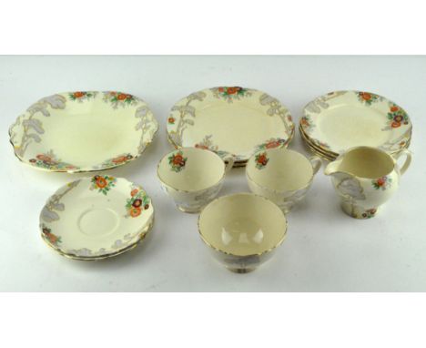 A Royal Cauldron Art Deco part tea service, decorated with tall trees and floral motifs, including tea cups, saucers, side pl