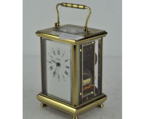 A brass cased Angelus carriage clock, the enamel dial with Roman numerals denoting hours, bevelled glass panels, 13.5cm high