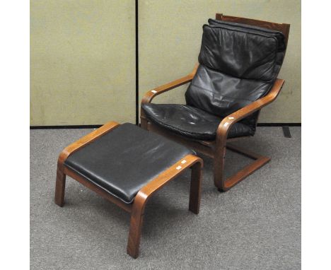 A vintage black leather cantilever chair with footrest, chair being 90cm high