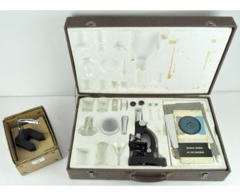 A cased microscope / science kit,, and a magnifier lens on stand