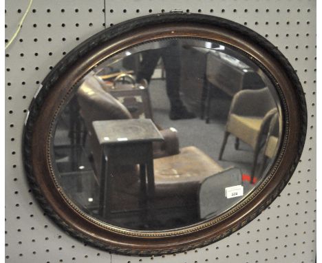 A vintage wall mirror of oval form with bevelled edge, 49cm x 59cm