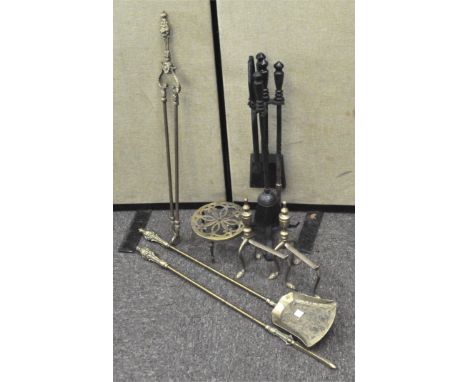A set of brass fireside tools including fire dogs
