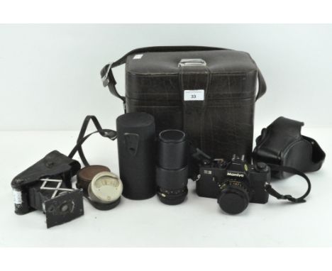 An Edwardian Eastman Kodak folding camera, a light meter and a Mamiya ZE slr camera with two lenses