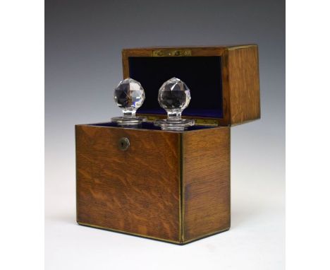 Late 19th/early 20th Century brass bound oak two division decanter box containing a pair of cut glass decanters and stoppers,