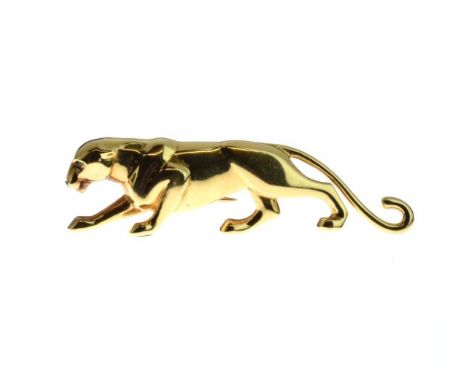 Cartier - Gold panther brooch, in a stalking pose, emerald set eyes, enamel nose, French control marks to the pin and tail, s