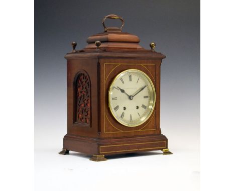 Early 20th Century brass inlaid mahogany cased bracket clock, the top with brass handle and four finials, fret-work side pane