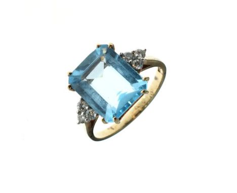 Blue topaz and diamond 9ct gold ring, the step cut stone with a trio of diamonds to each shoulder, size O, 4.4g gross  Condit