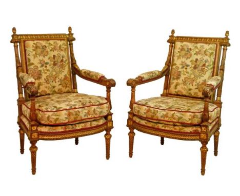 Pair of French carved walnut and giltwood open arm elbow chairs, each upholstered in floral patterned simulated tapestry and 