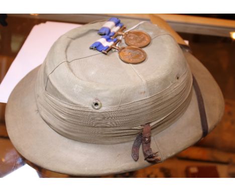 PITH HELMET. Pith helmet and two Oriental medals