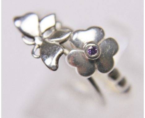 PANDORA STYLE RINGS. Two sterling silver Pandora style rings, one butterfly the other flower, size O and M/N