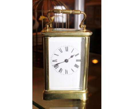 CARRIAGE CLOCK. Brass carriage clock with bevelled glass panels and key