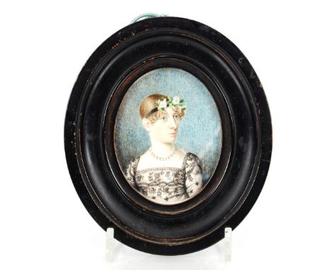 19th Century school,&nbsp;miniature bust length portrait of a lady with flowers in her hair, contained in oval ebonised frame